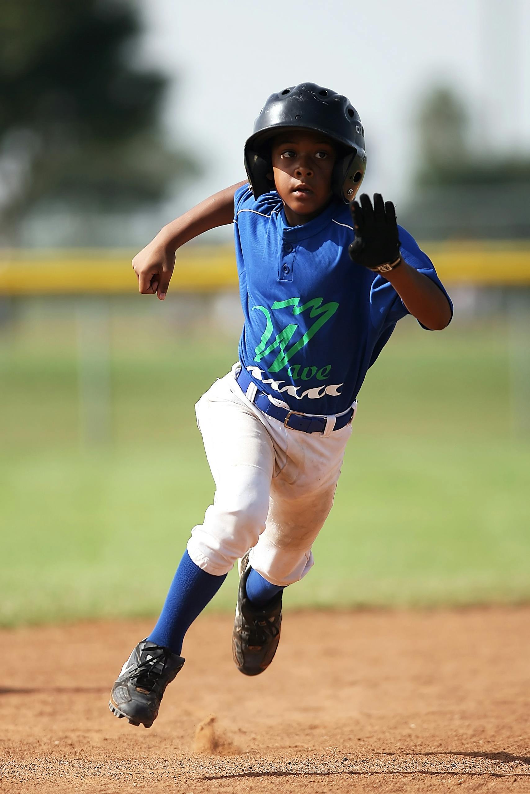 Little League Coaching: 7 Steps to Helping Young Athletes Thrive On and Off the Field 10 A child sprints energetically across the baseball field, showcasing agility in the sport.