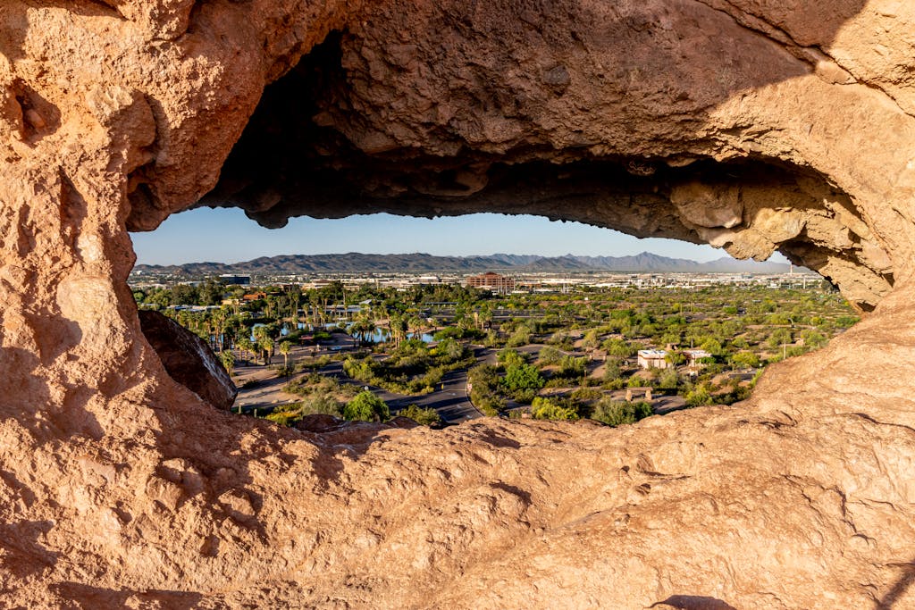 Capture of Phoenix cityscape through a unique rock formation in Papago Park, Arizona.